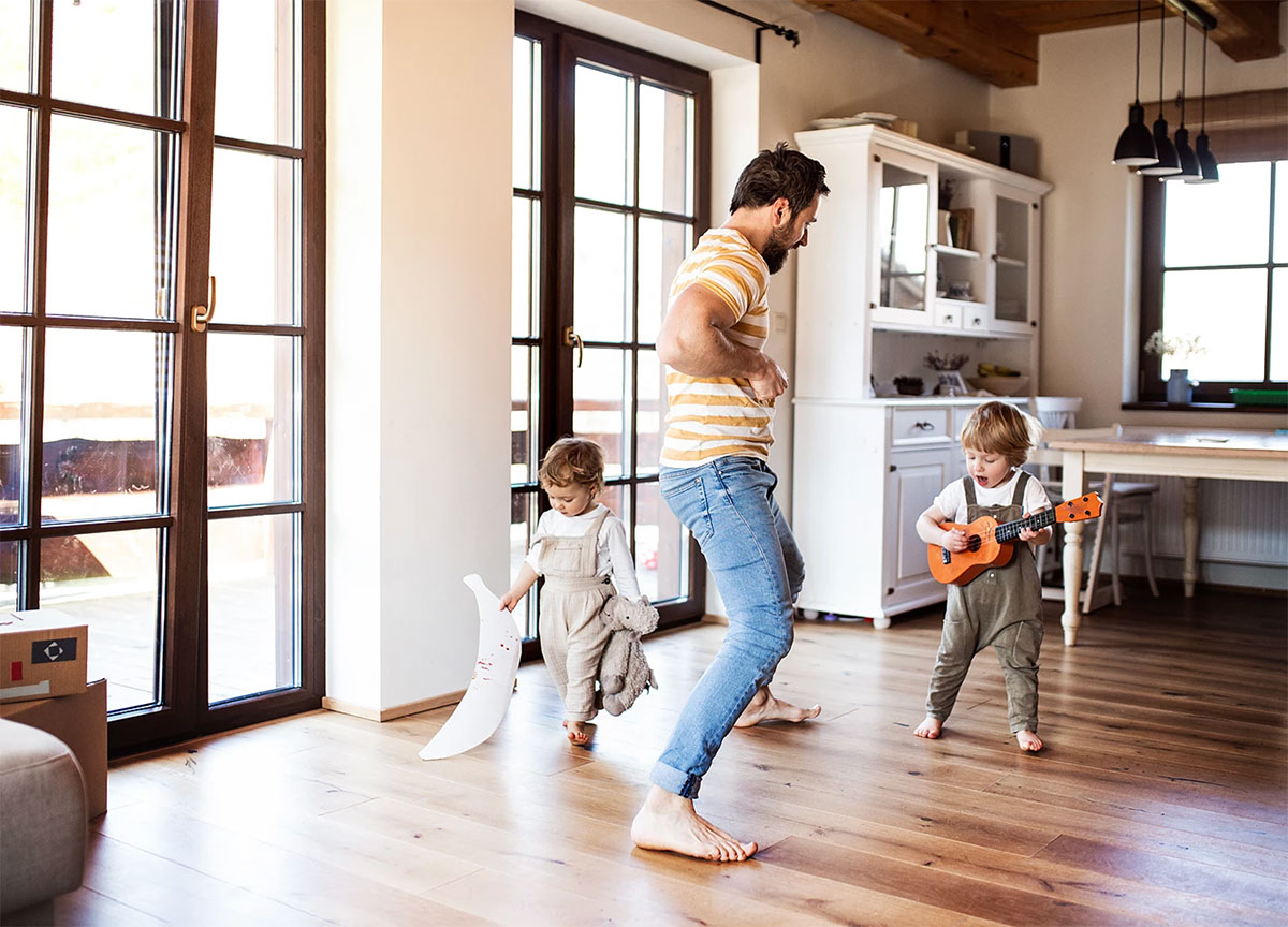 father dancing with young kids