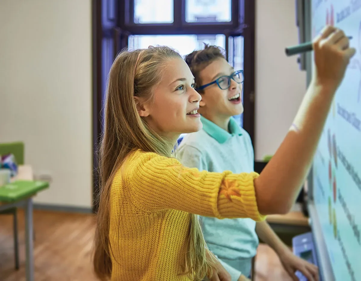 students writing on whiteboard